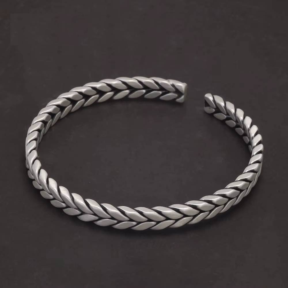 Braided pure silver cuff bracelet on black background