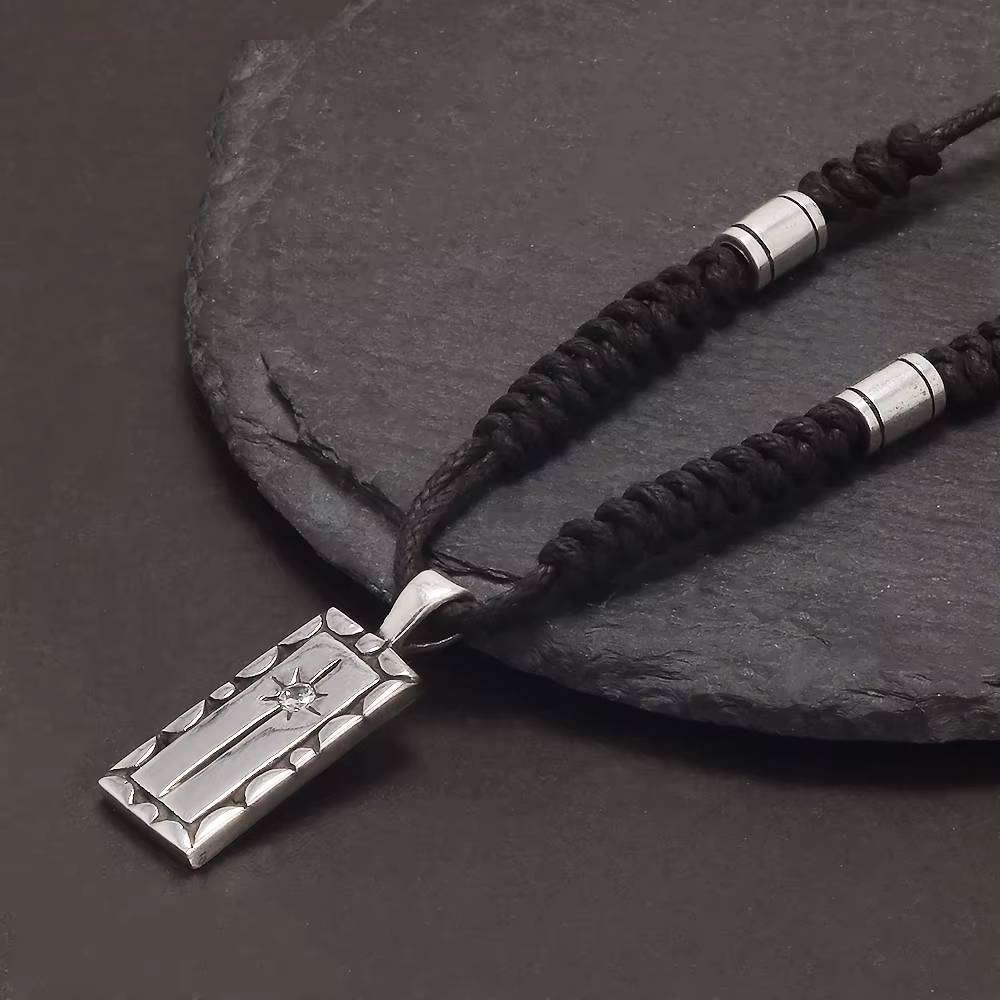 Star-engraved silver pendant with adjustable rope necklace
