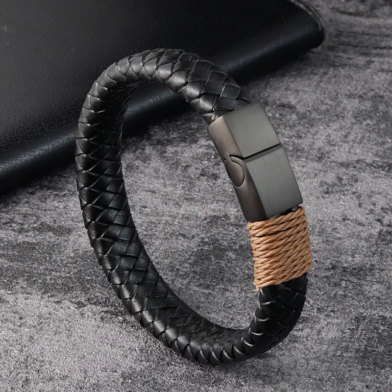 Black braided leather men’s bracelet with matte black magnetic clasp and thread wrap detail