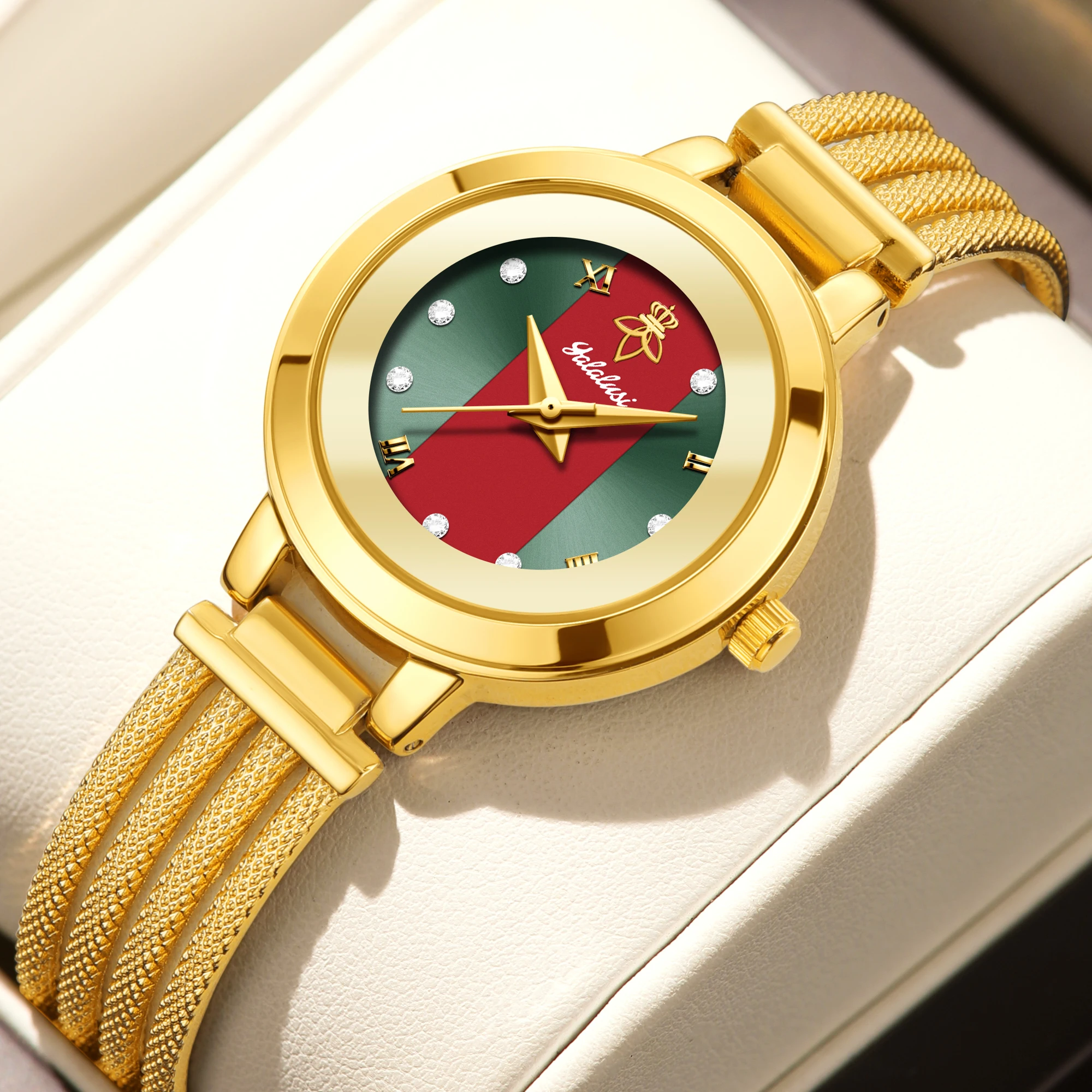 Red dial gold watch with bracelet-style cuff band for women