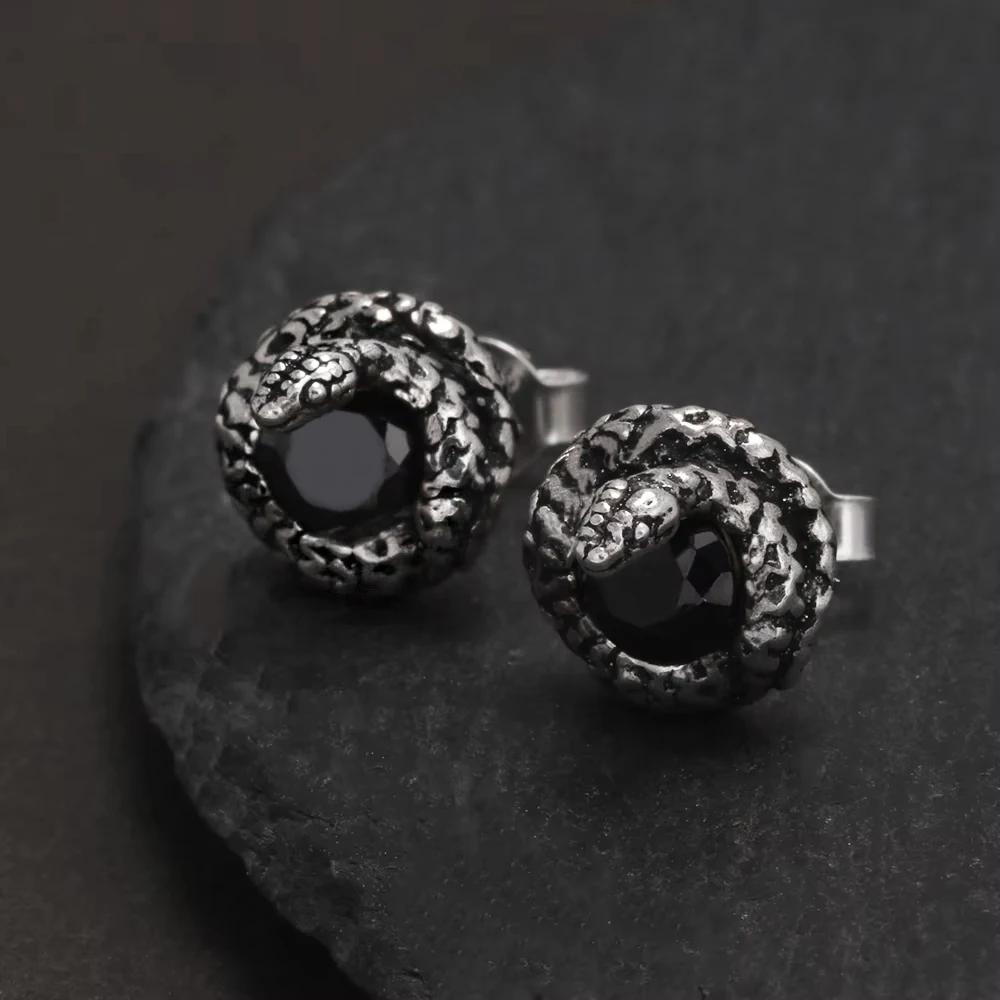 Close-up of gothic snake stud earrings with faceted black onyx stone