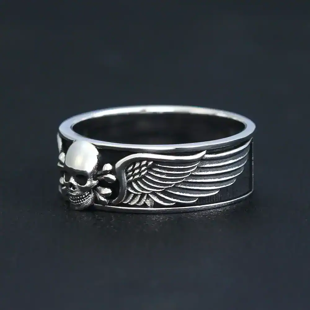 Detailed skull with wing design in polished silver finish.