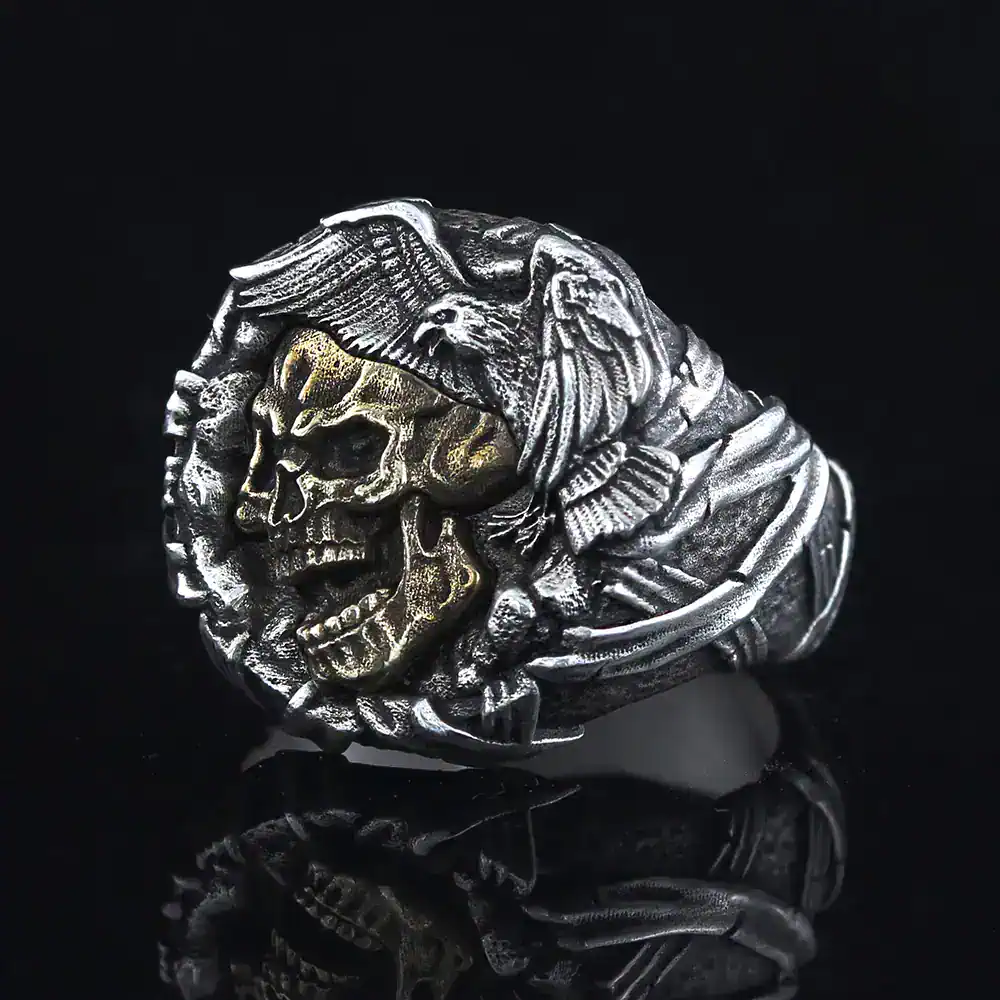 Detailed silver-tone skull eagle biker ring for men. Gothic jewelry, edgy accessory.