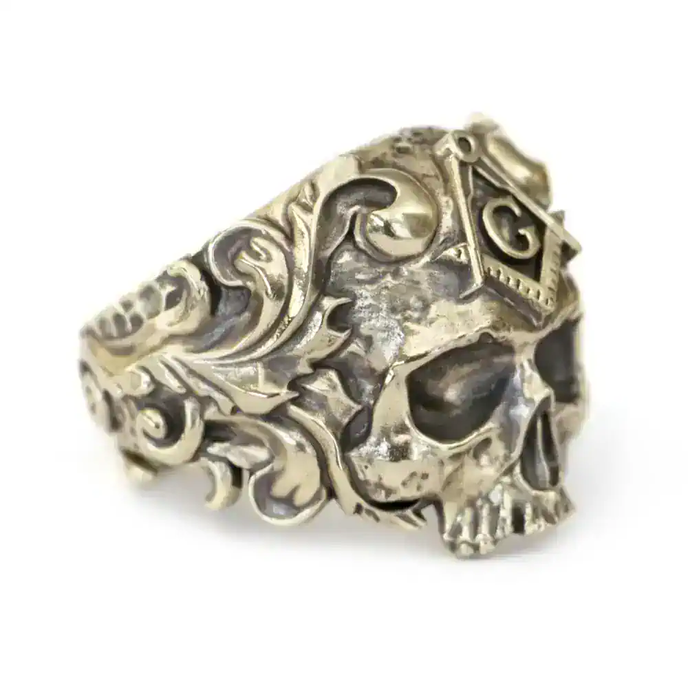Intricate silver skull ring featuring gothic filigree and a square 