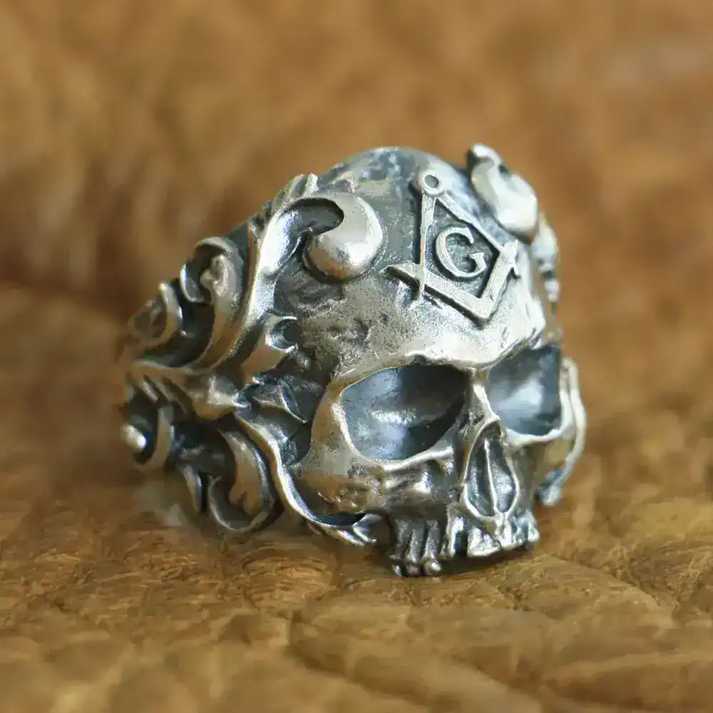 Intricate silver skull ring with Masonic square and compass emblem for men and women.