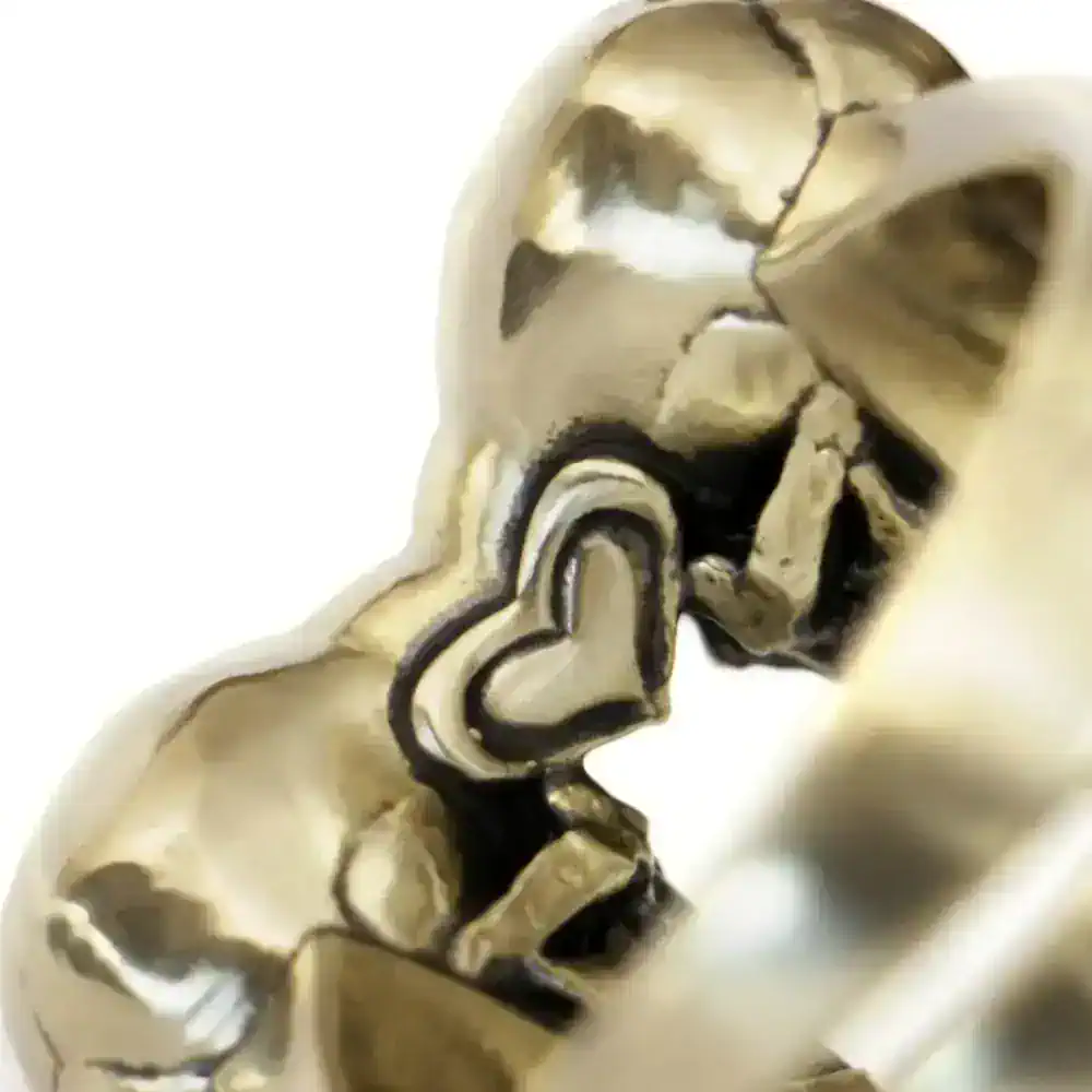Bold gold skull ring with intricate detailing, perfect for edgy fashion statements.