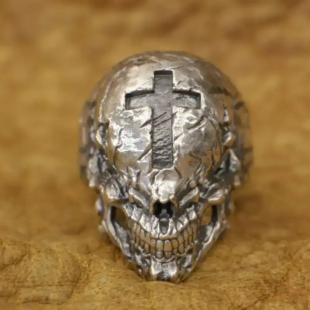Intricate skull ring featuring a prominent cross design, crafted for edgy style and statement accessories.