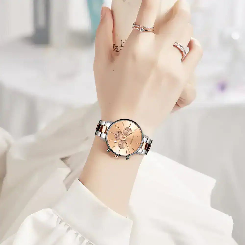 Beautiful rose gold and silver watch with chronograph features and sleek design.