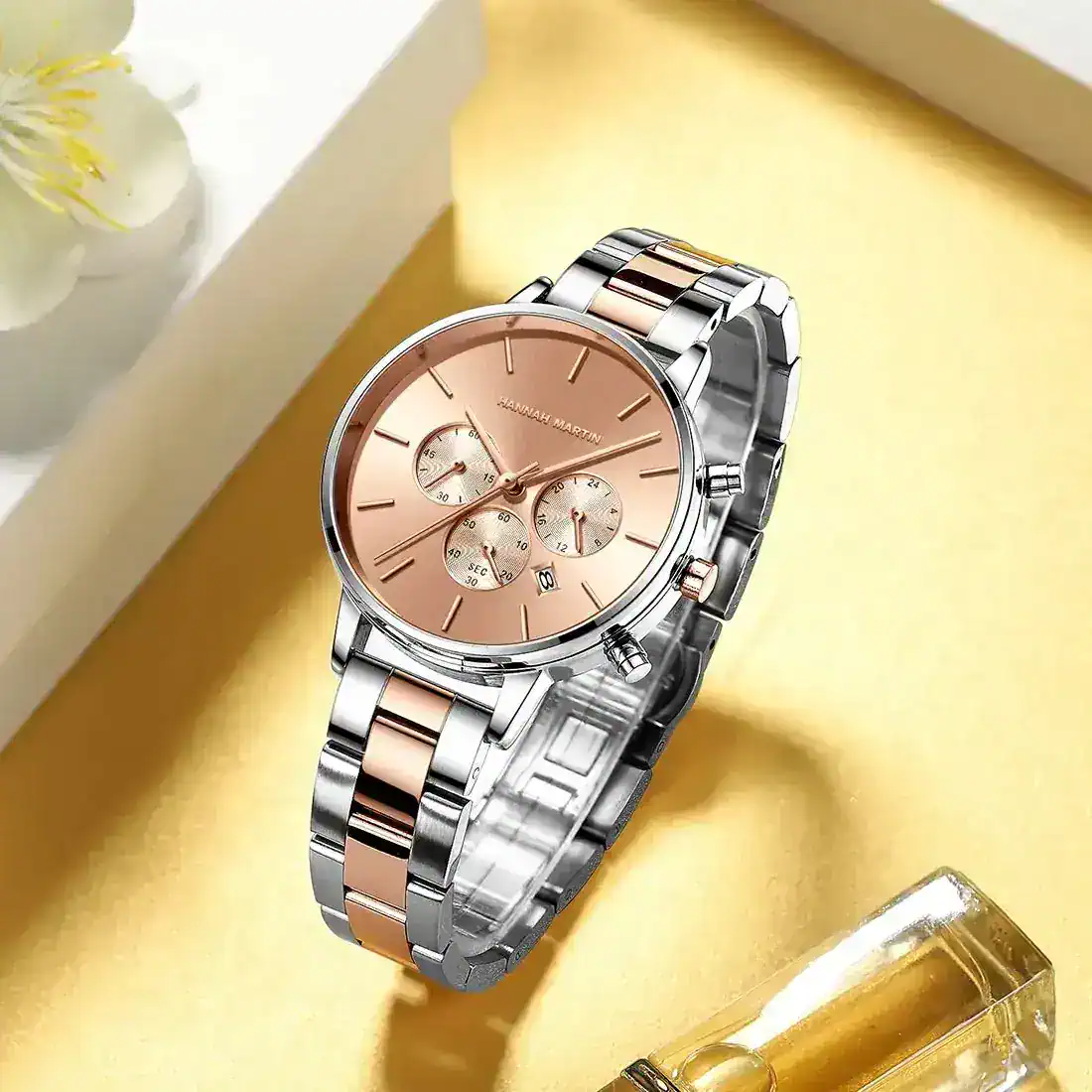 Luxury two-tone stainless steel bracelet with rose gold accents, precise chronograph movement.