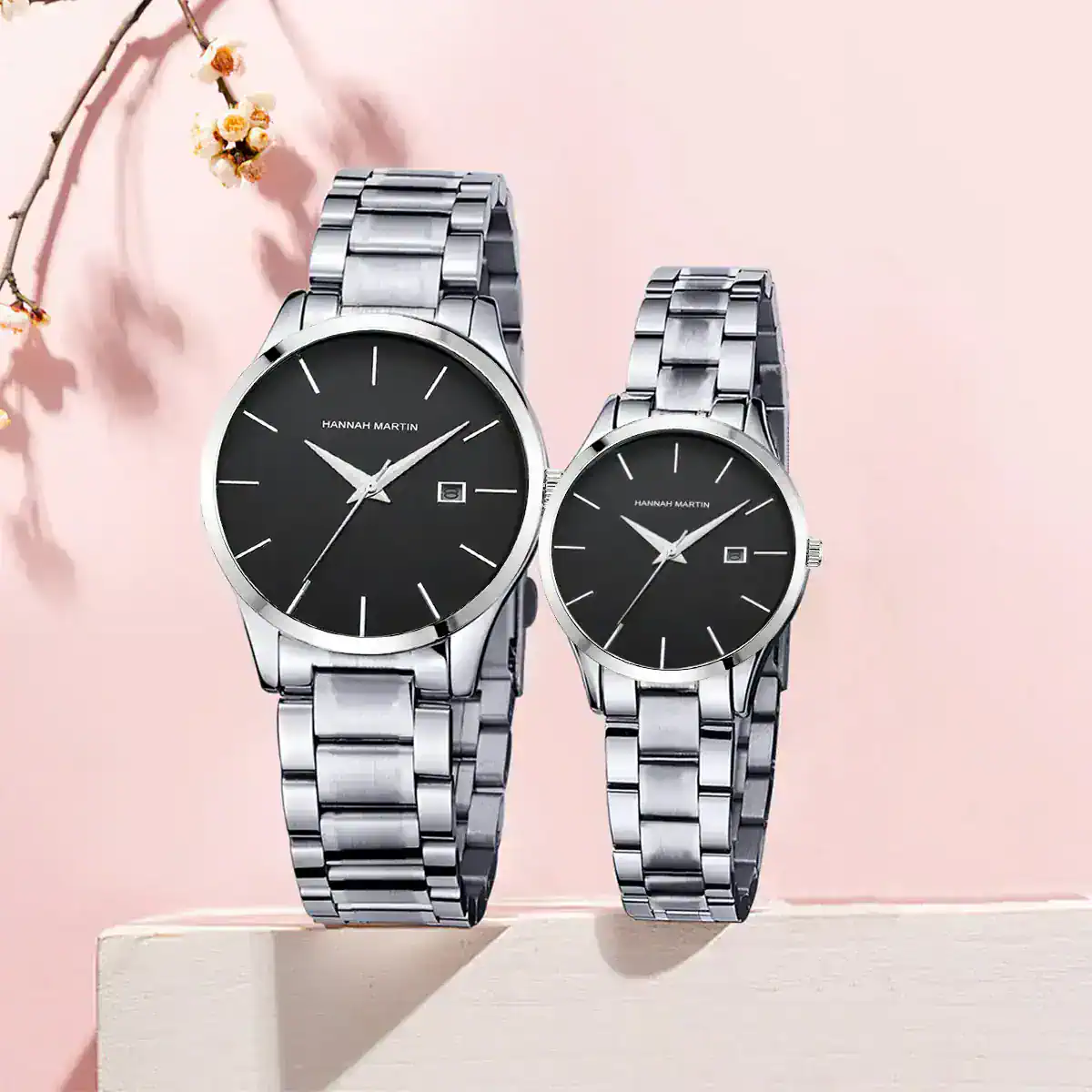 Stylish silver stainless steel watch duo for men and women, featuring black watch face and date function.
