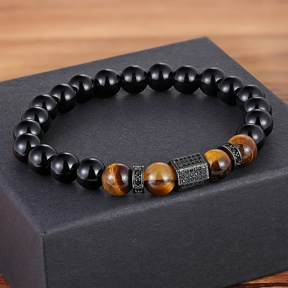 Elegant men's beaded bracelet featuring black onyx and tiger's eye stones with black diamond-shaped spacer charms.