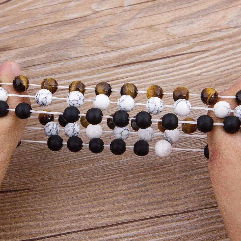 Stylish beaded necklace with black, white, and tiger's eye stones for fashion-forward accessories.