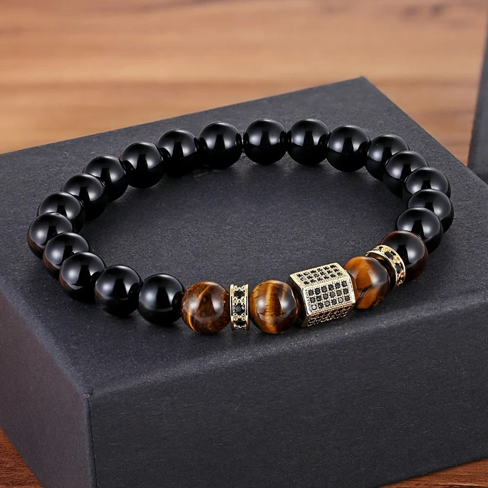 Stylish men's beaded bracelet featuring black and brown polished beads with gold-tone spacers and decorative cube.