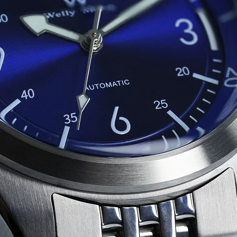 Close-up of a luxury blue dial wristwatch featuring stainless steel case and bracelet, automatic movement, and precise timekeeping.