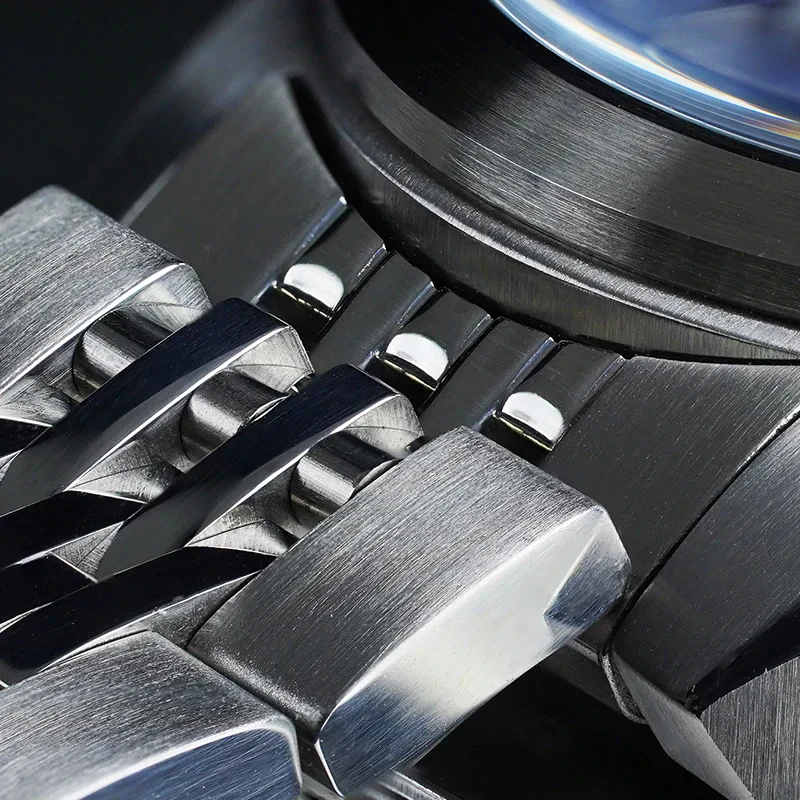 Close-up of polished stainless steel jewelry pieces with sleek design.