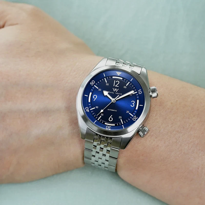 Stainless steel wristwatch with blue dial, automatic movement, and luminous hands for men.