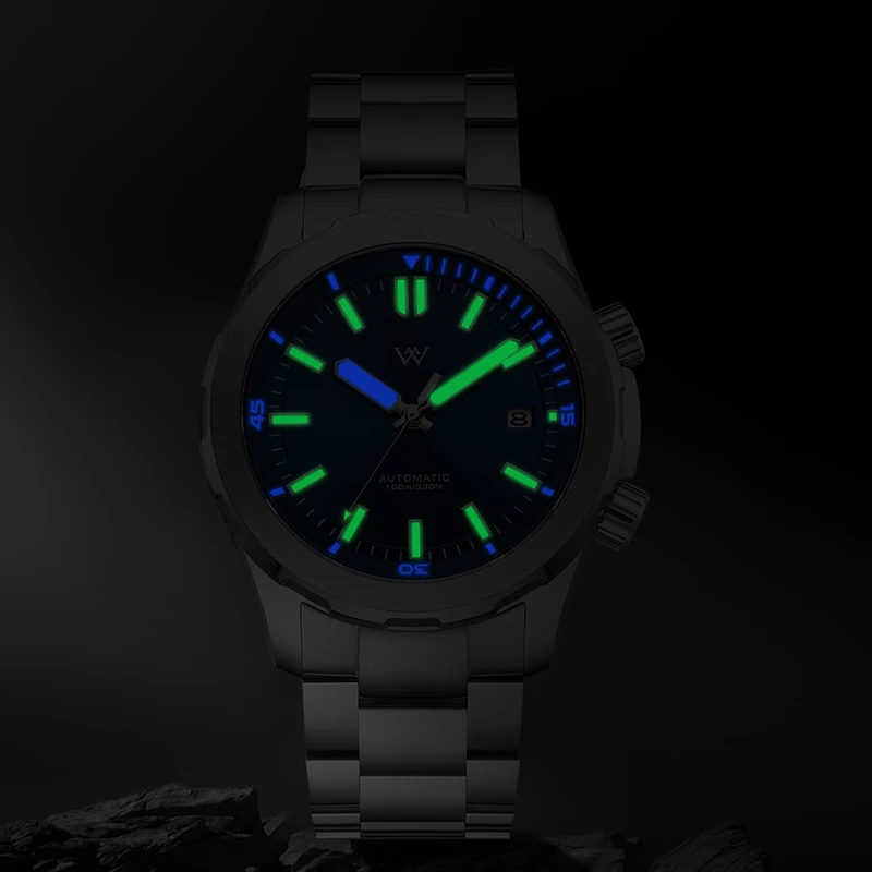 Black luminous dive watch with green and blue glow, automatic movement, stainless steel band.