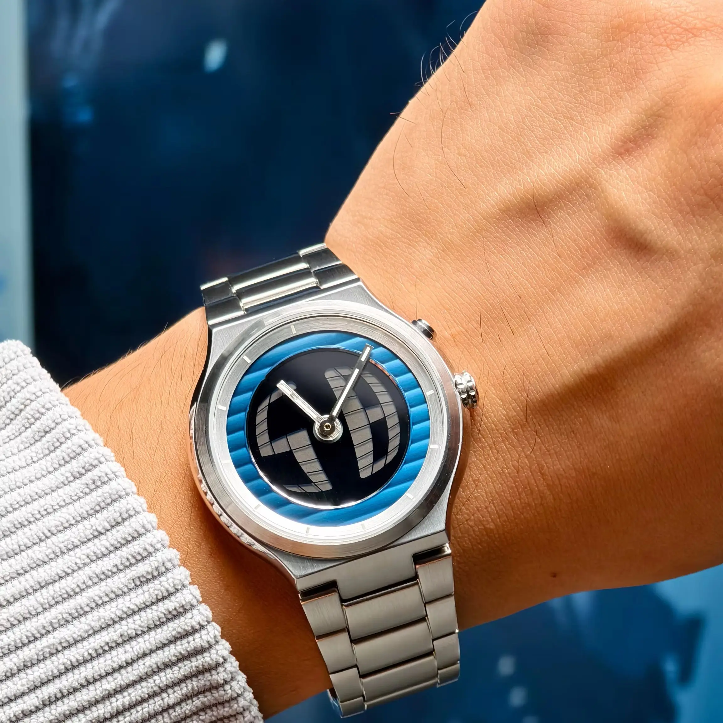 Stainless steel wristwatch with a bold blue and black dial, perfect for stylish accessories.