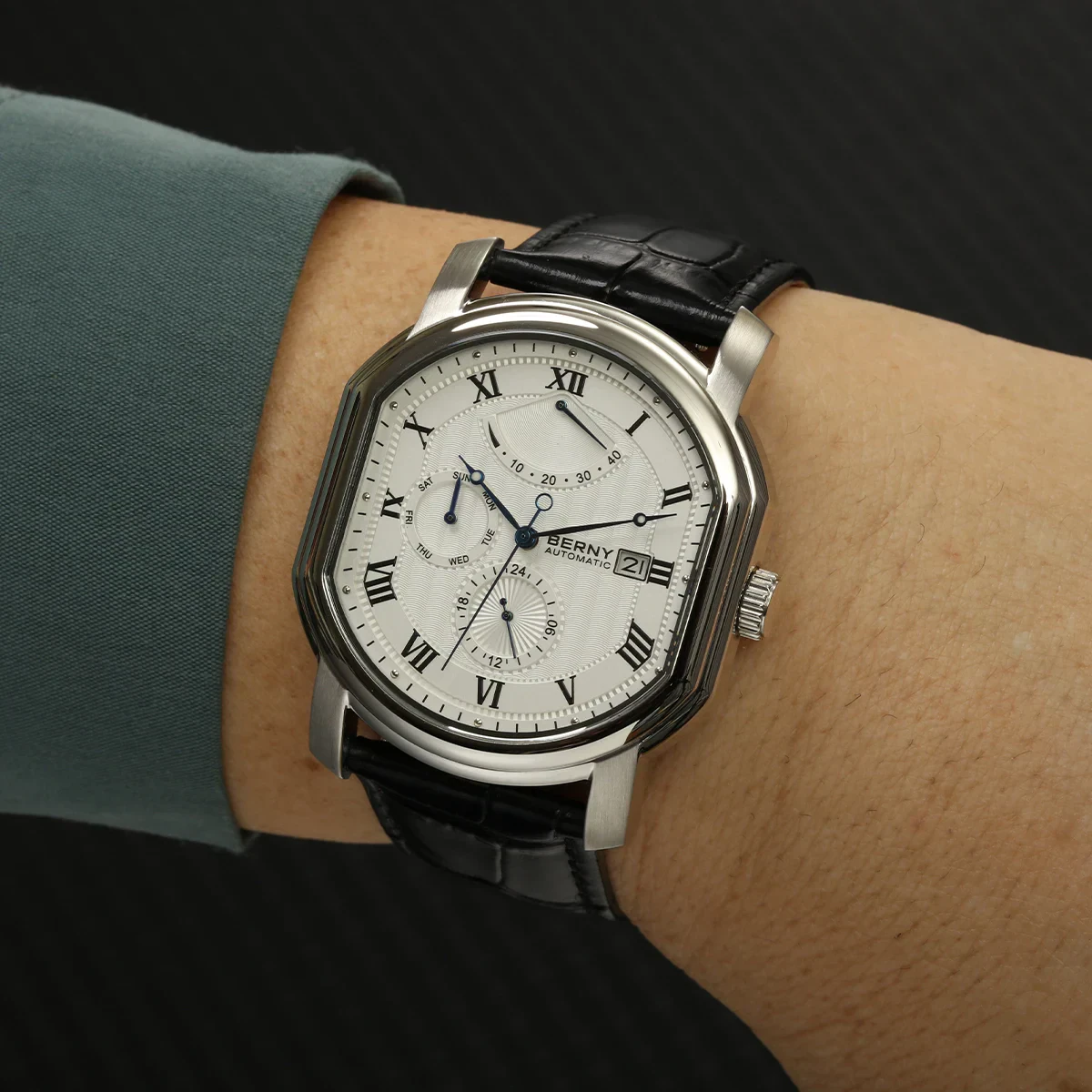 Elegant men's wristwatch featuring a sophisticated round face, chronograph features, and a black leather strap.