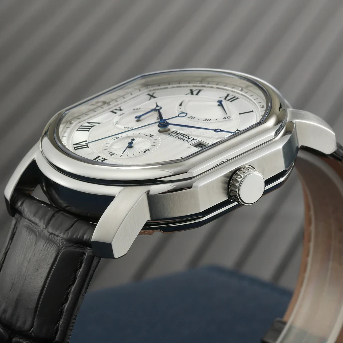 Luxury men's silver chronograph watch with leather band, automatic movement, and multi-dial features.