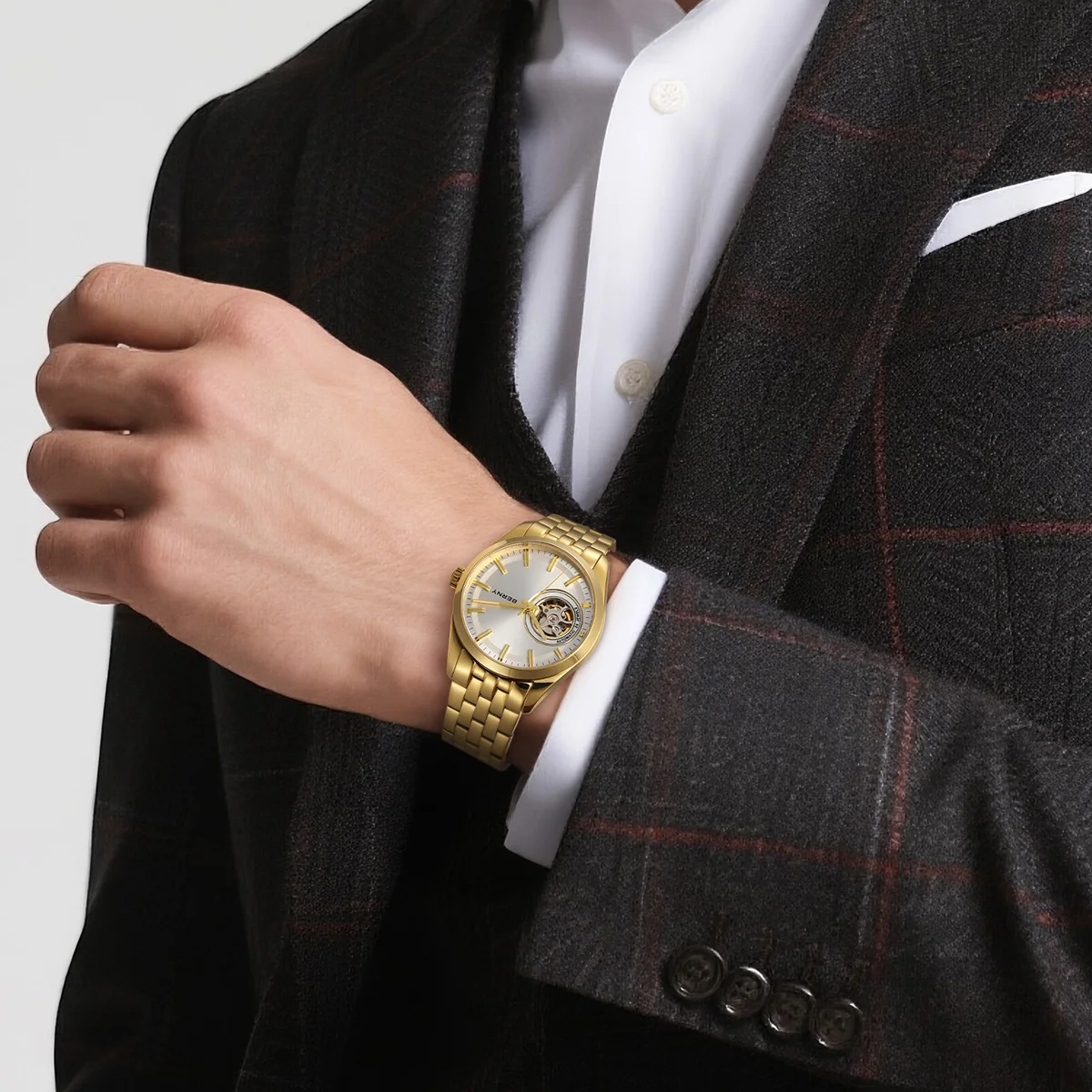 Elegant gold skeleton watch displayed on man's wrist for sophisticated style.