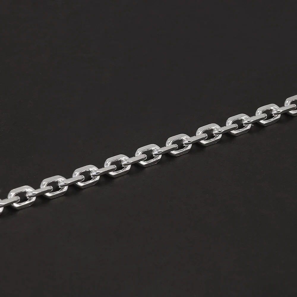 Close-up of a sleek silver chain with rounded link design on black background.