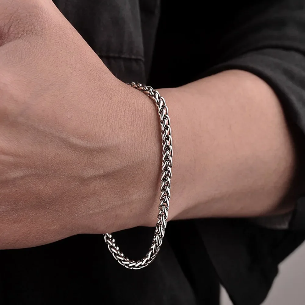 Elegant silver chain bracelet on wrist featuring link detail, perfect for jewelry lovers.
