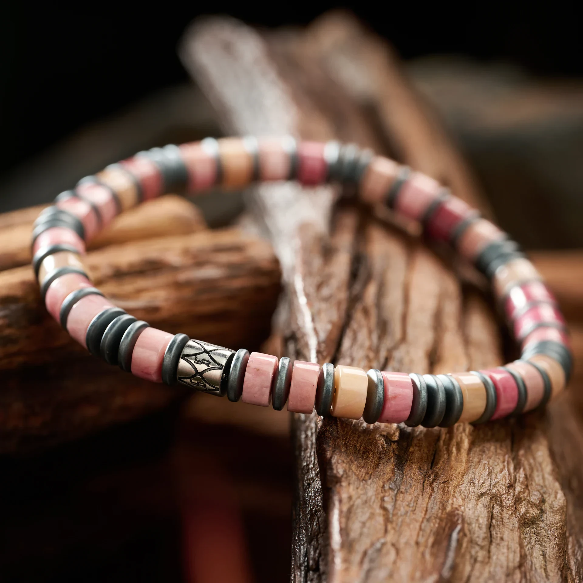 Pink and gray beaded jewelry with silver accents, perfect for enhancing casual or boho-chic outfits.
