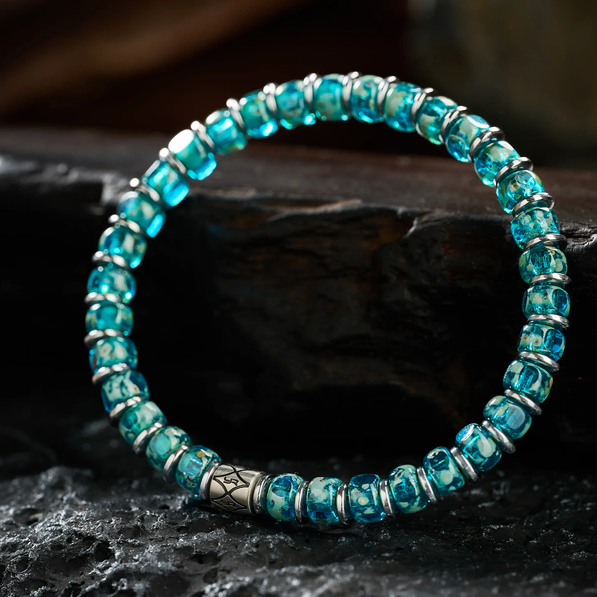 Vibrant blue glass beads with silver accents, stylish jewelry for men and women.