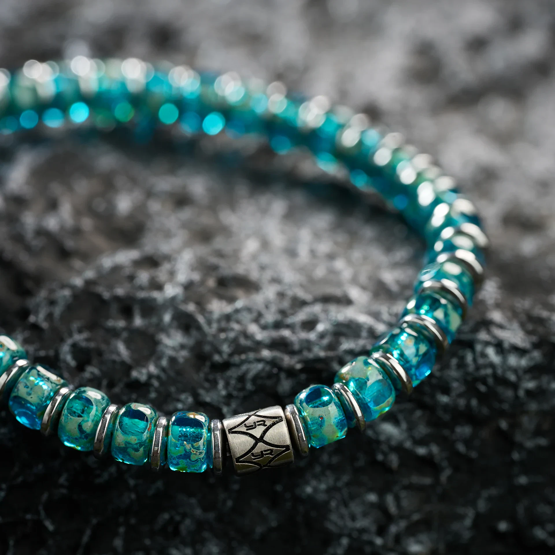 Close-up of a stylish blue beaded bracelet with silver spacer beads and a decorative clasp, perfect for jewelry lovers.