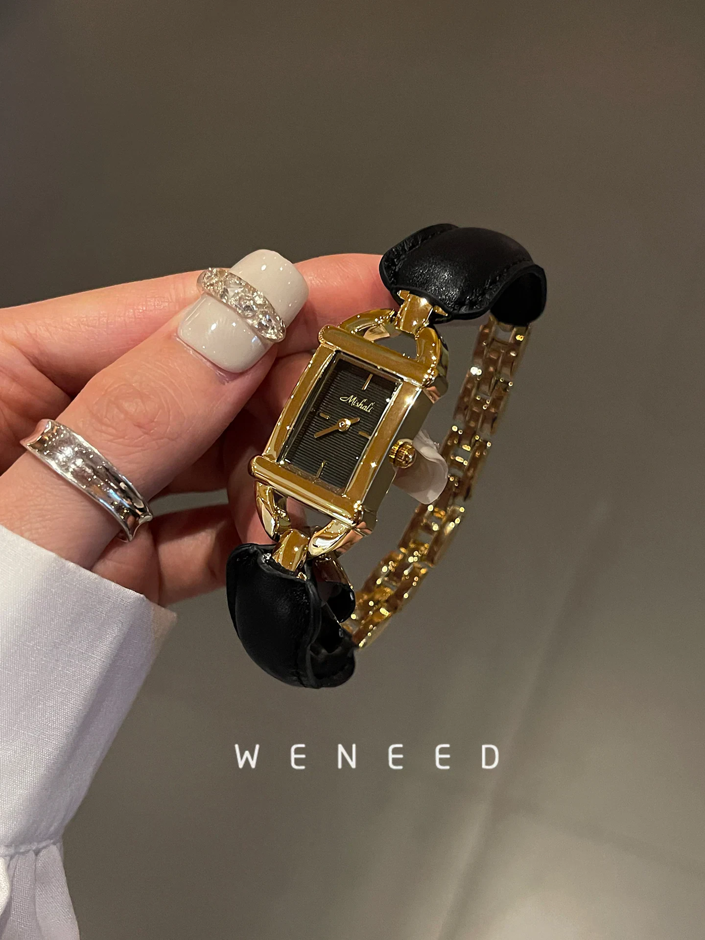 Luxurious gold-tone rectangular wristwatch with a black leather band, perfect for classic and stylish looks.