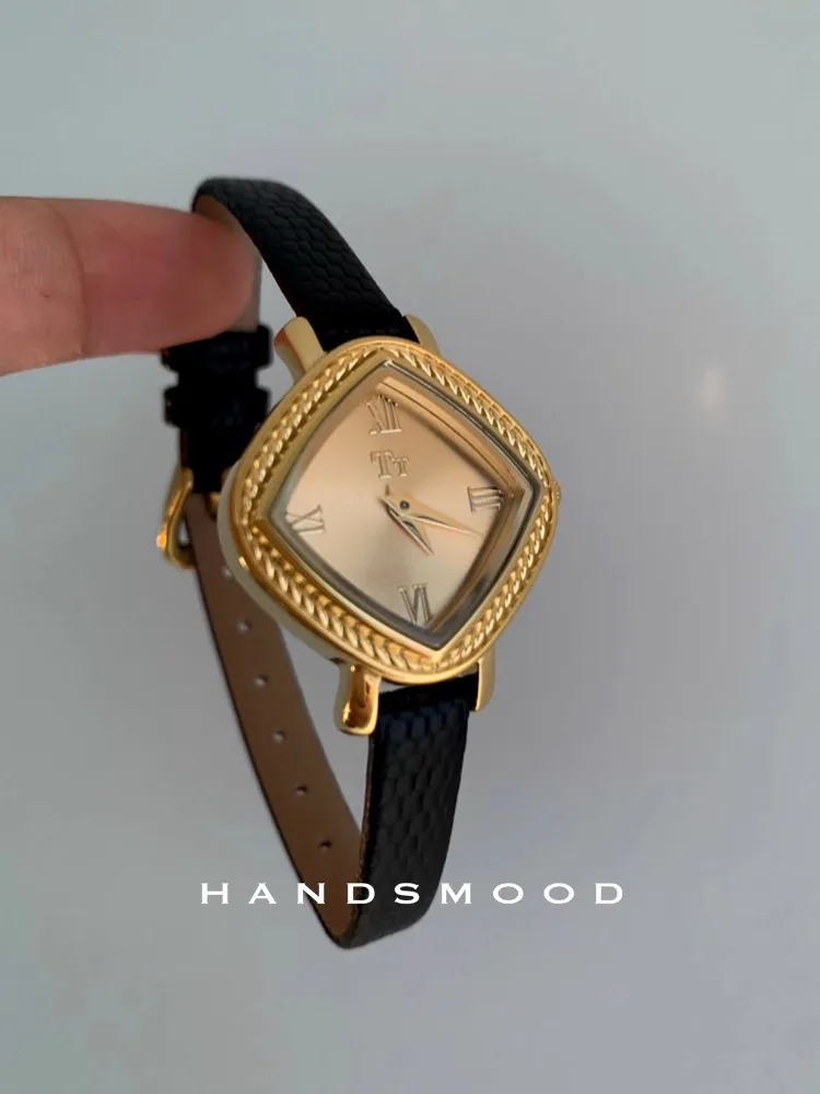 Elegant gold-tone square wristwatch with Roman numerals and black textured leather band.