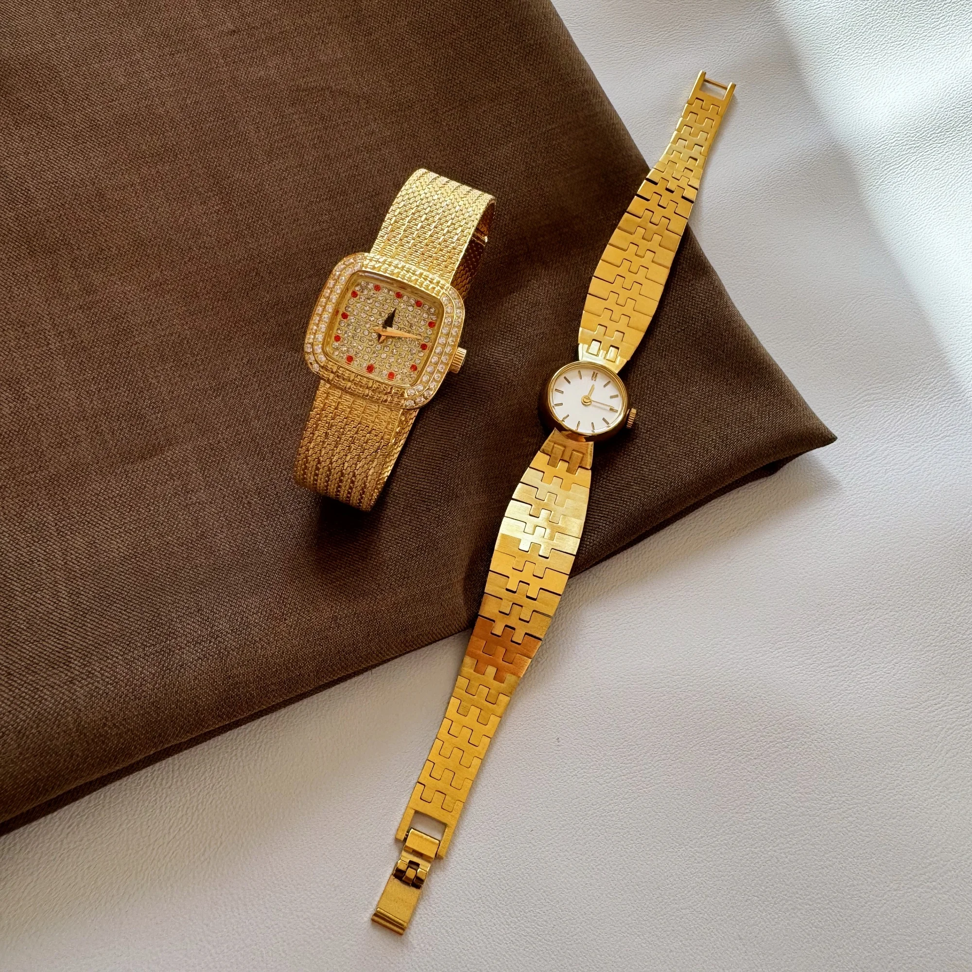 Elegant gold watches with sparkling crystals and stylish bands for women’s luxury jewelry collection.