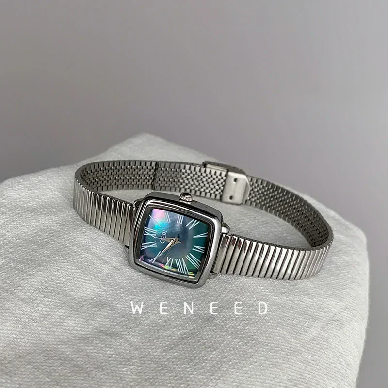 Luxury stainless steel wristwatch with Roman numerals and a sleek square face.