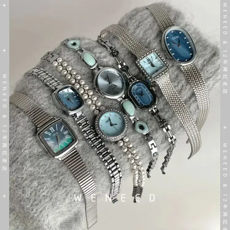 Stylish women's and men's watches with stainless steel bands and modern design.