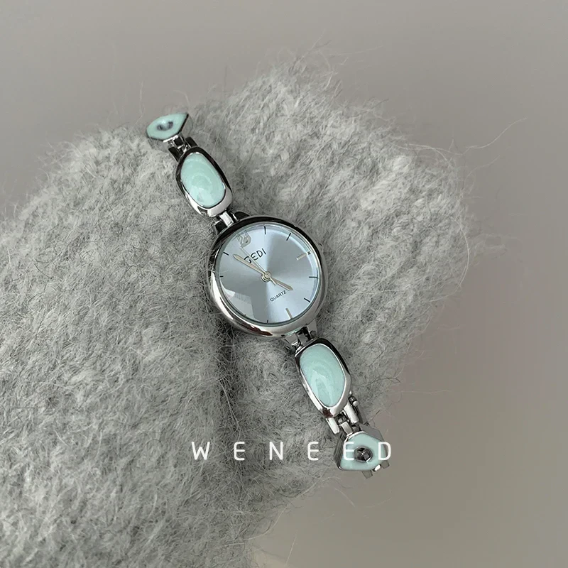 Stylish women's watch with mint green accents and silver-tone bracelet for everyday wear.
