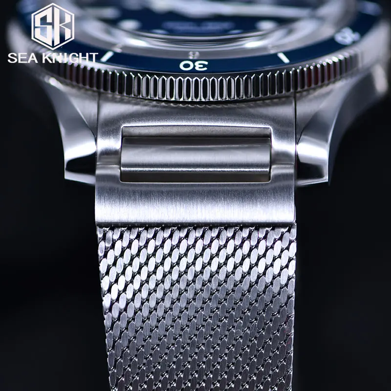 Close-up of stainless steel mesh band and watch face, luxury men's wristwatch design.
