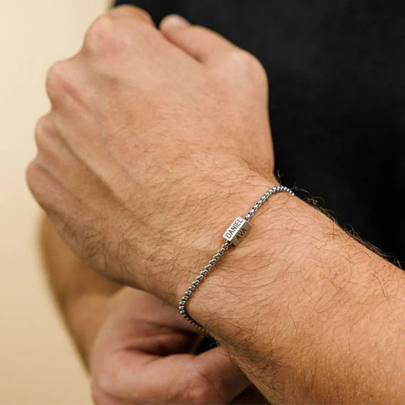 Personalized silver bracelet with engraved name tags, custom jewelry gift for men and women.