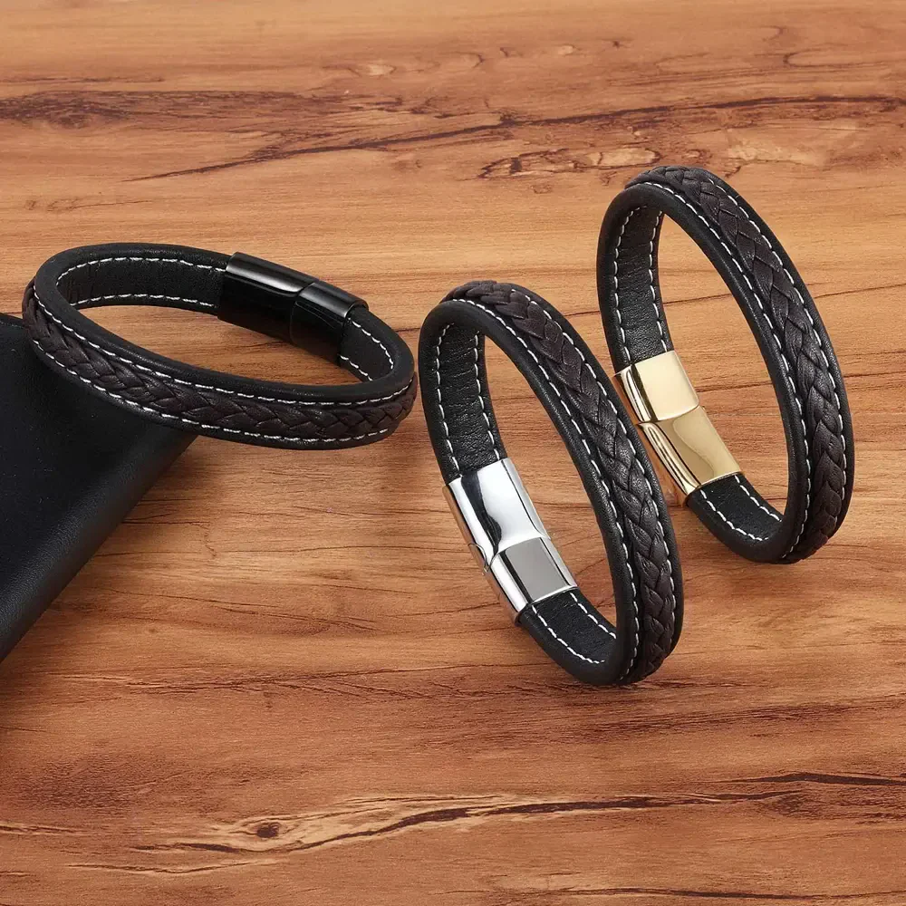 Elegant leather bracelet set featuring braided and smooth black leather with silver and gold clasps, perfect for men's fashion.