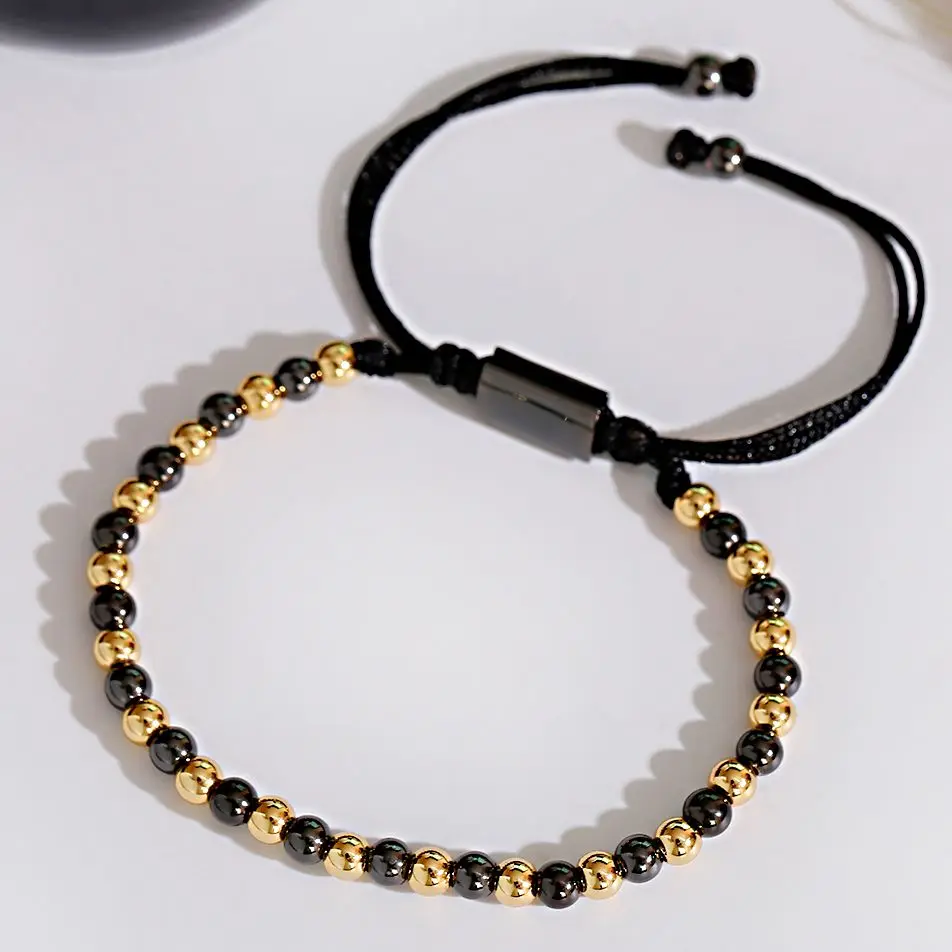 Black and gold beaded necklace with adjustable cord, stylish jewelry accessory.