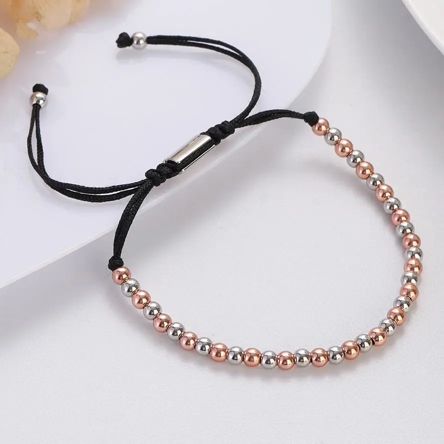 Bracelet with pink and silver beads, adjustable black cord, perfect for stylish accessorizing.
