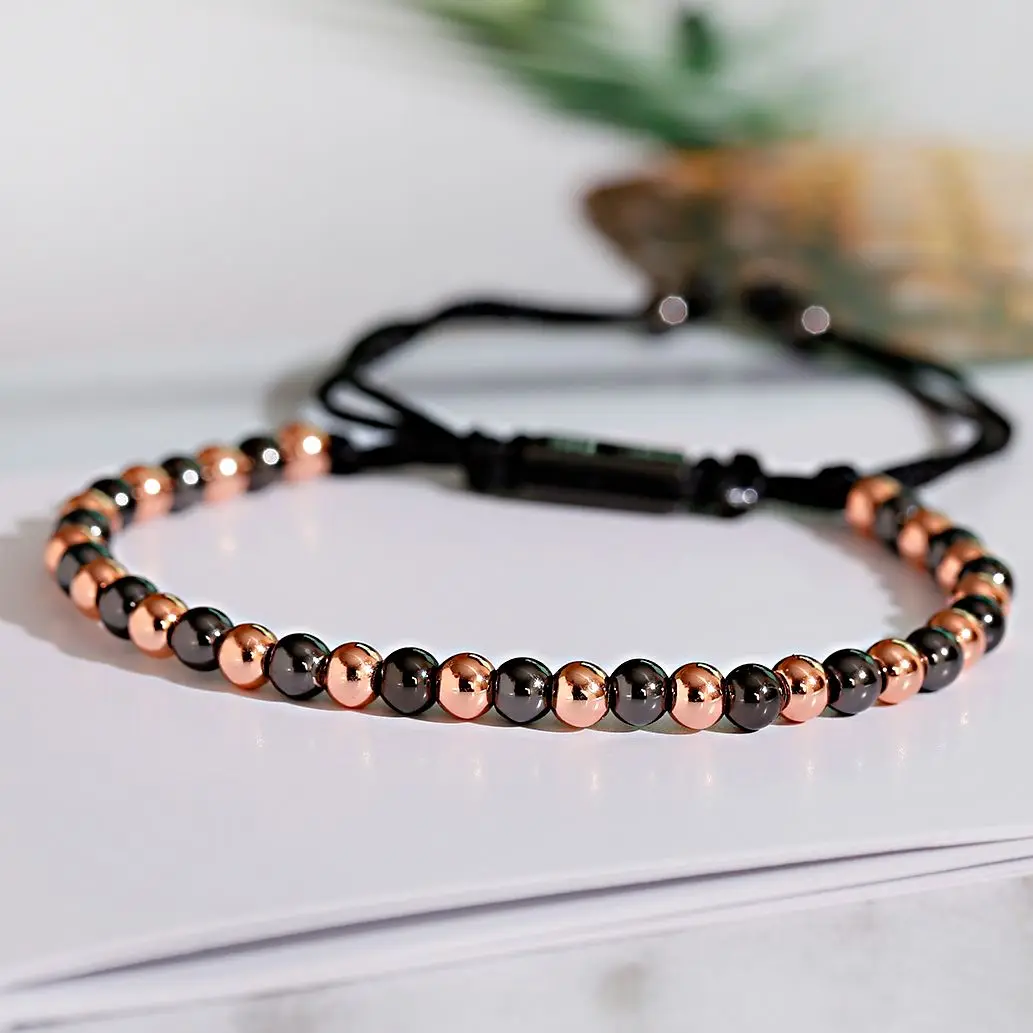 Stylish black and rose gold beaded necklace with adjustable black cord. Perfect for casual or elegant wear.