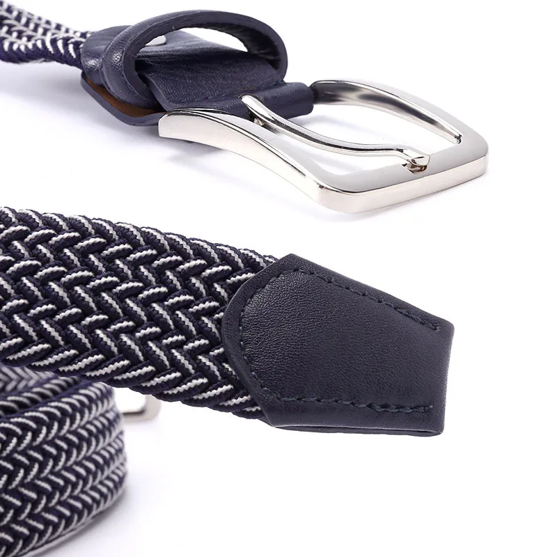 Close-up of stylish woven navy belt with polished silver buckle and leather tips, ideal for fashion accessories.