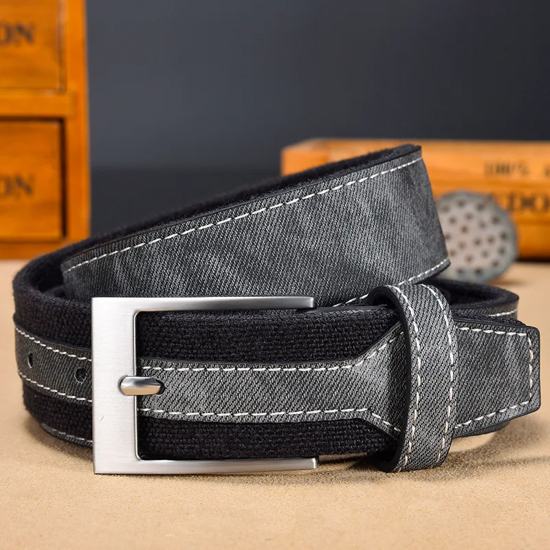 Stylish black fabric and leather belt with silver buckle, perfect for everyday wear.