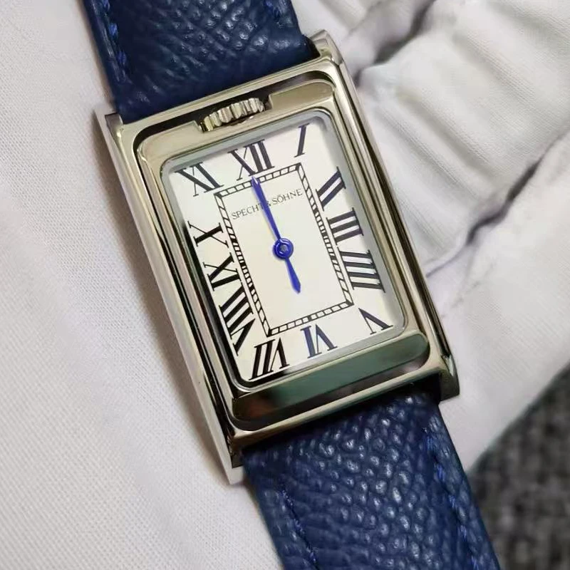 Luxury rectangular watch with blue leather strap and Roman numeral dial.