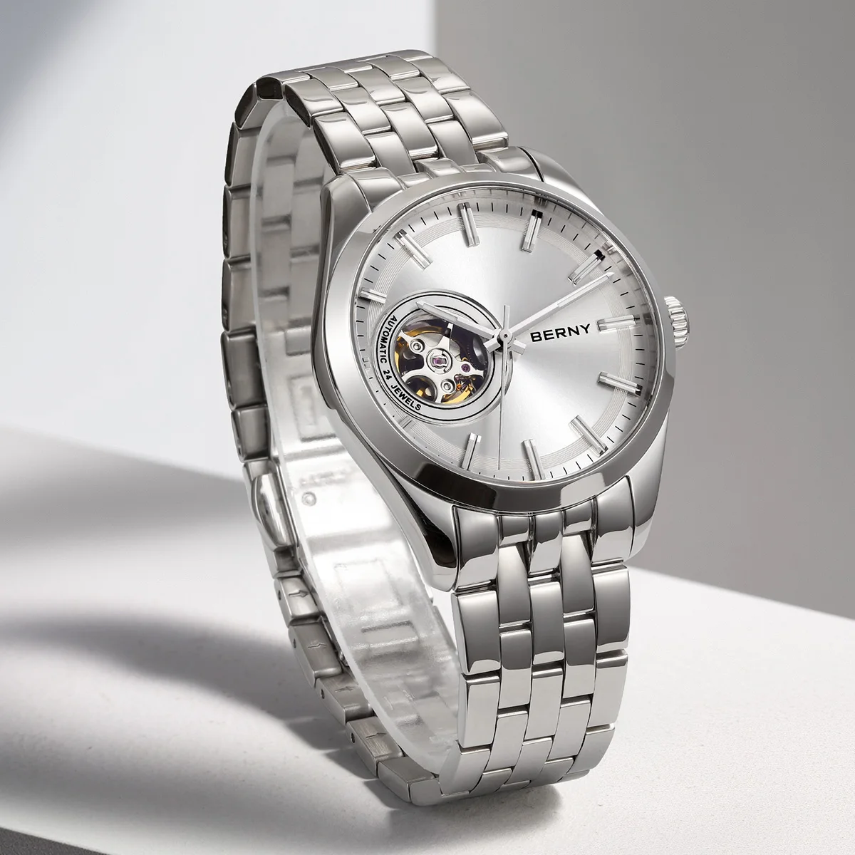 Luxury silver men's watch with open heart feature, automatic movement, and stainless steel band.