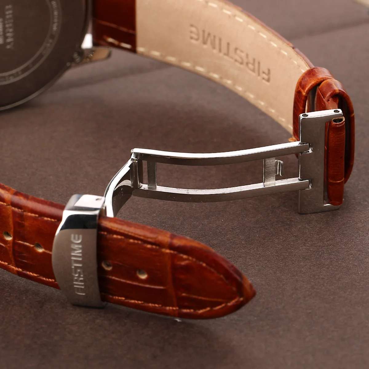 Luxurious brown leather watch strap with stainless steel clasp. Perfect for stylish men's accessories.