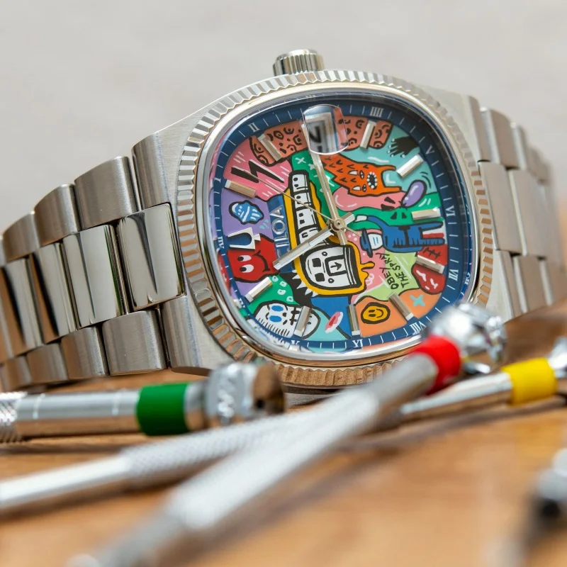 Vibrant, artistic wristwatch featuring a colorful, playful dial design and a stainless steel band.