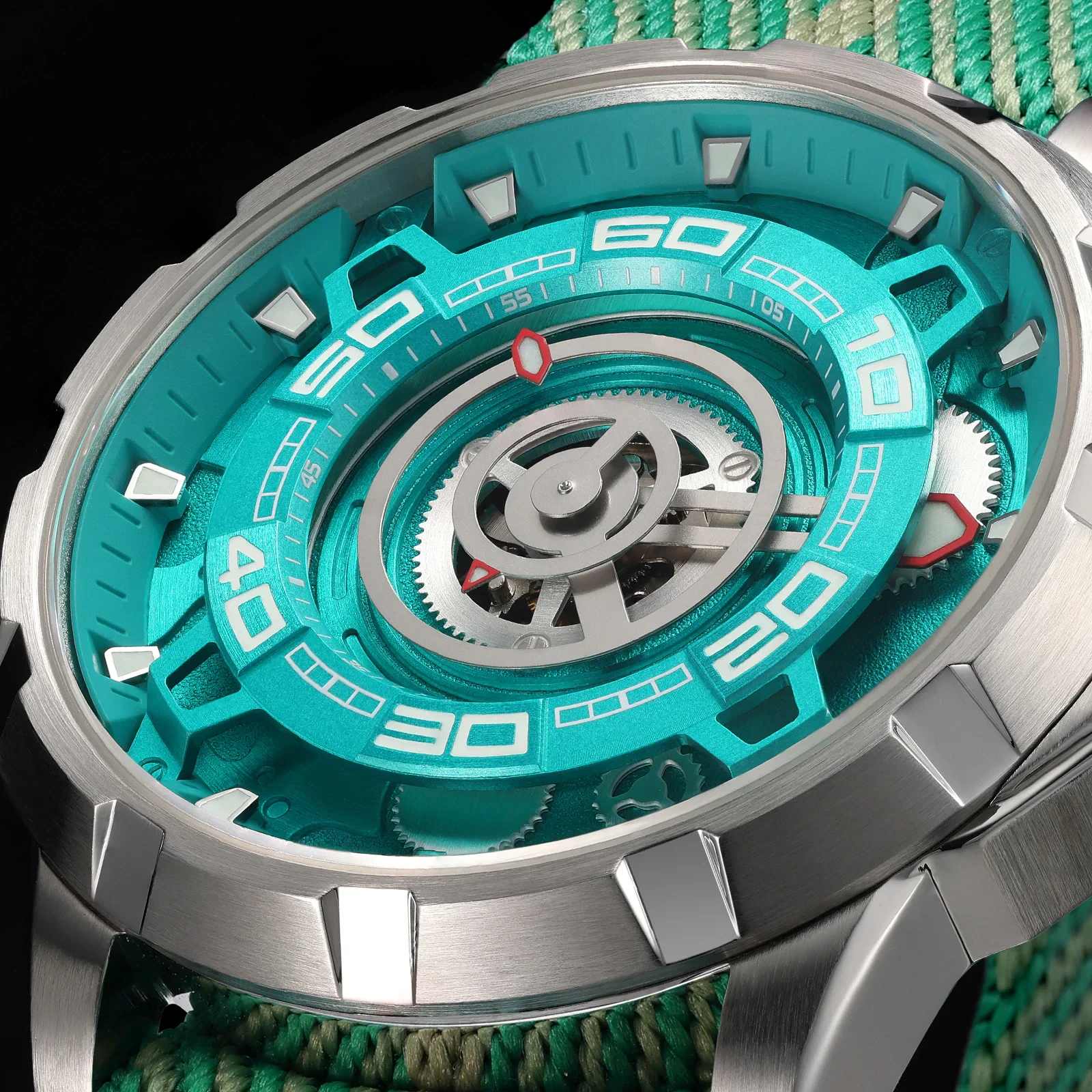 Bright teal watch face with skeleton movement and silver case.