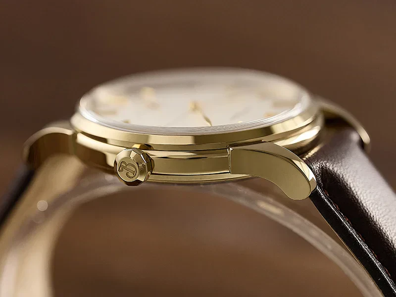 Luxury men's gold wristwatch with black leather strap, classic design, and minimalist dial for formal wear.